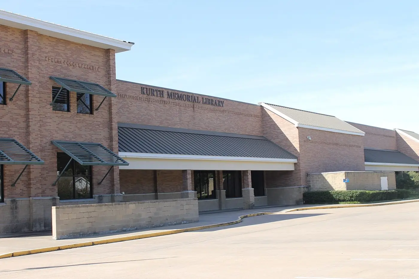 Brick front of the Kurth Memorial Library with metal awnings